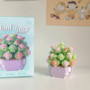A purple miniature flower bouquet made of building blocks is displayed next to its packaging.