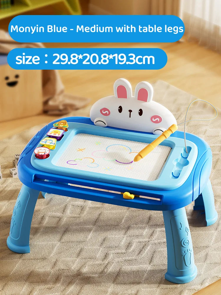 A blue magnetic drawing board with table legs and a white rabbit figure is shown on a light fabric.