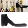 A black guitar wall mount hanger with soft padding, shown alongside several guitars.