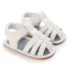 A pair of white breathable baby first walker sandals with a soft anti-slip sole.