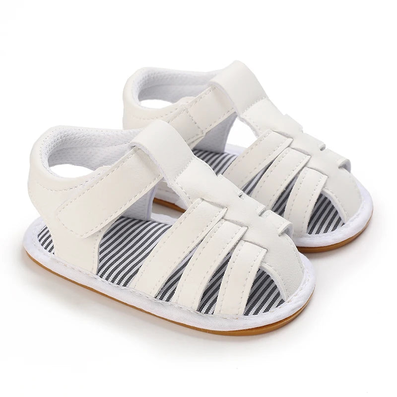 A pair of white breathable baby first walker sandals with a soft anti-slip sole.