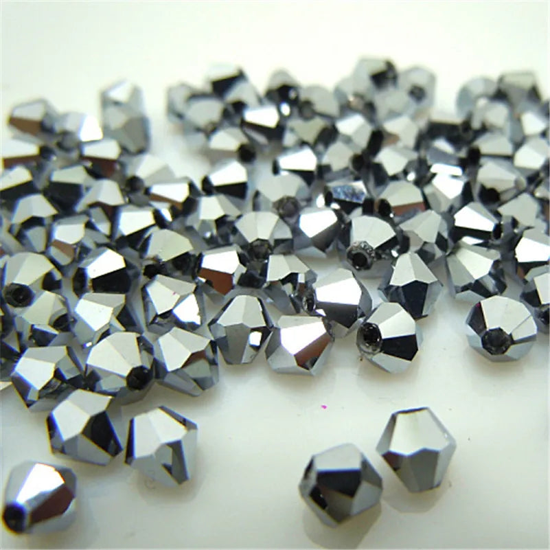 A pile of silver faceted glass bicone beads for jewelry making