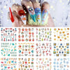 A hand displays various Christmas and winter themed nail art stickers for manicure designs.