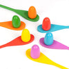A set of colorful plastic Easter eggs and spoons in various bright colors like orange, green, red, yellow, and blue.