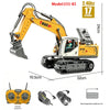 Yellow RC excavator model 555-83 with interchangeable attachments, batteries, and remote control.