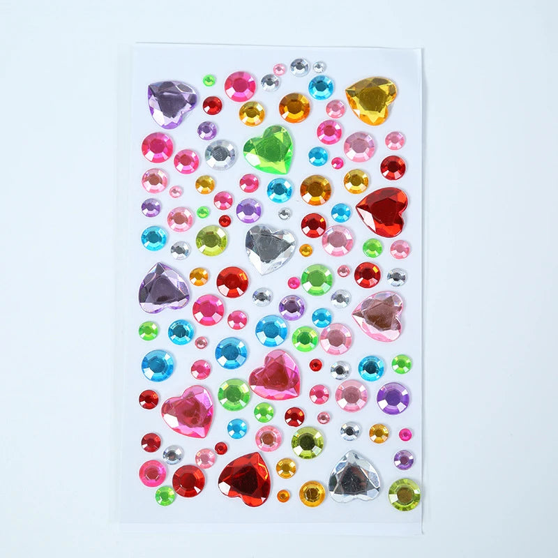 A colorful arrangement of various clear and colored acrylic gem stickers for face, nails, and crafts