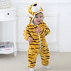 A baby wearing a yellow and black striped animal hooded romper with a lion face mask.