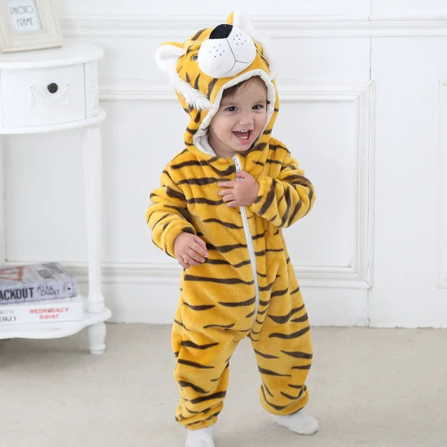 A baby wearing a yellow and black striped animal hooded romper with a lion face mask.