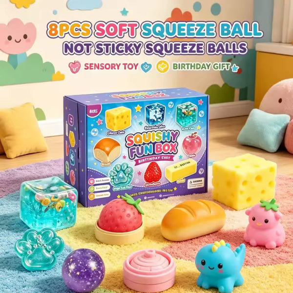 A box of 8 pieces of soft squishy balls in various colors and shapes including yellow, pink, and blue, displayed on a surface