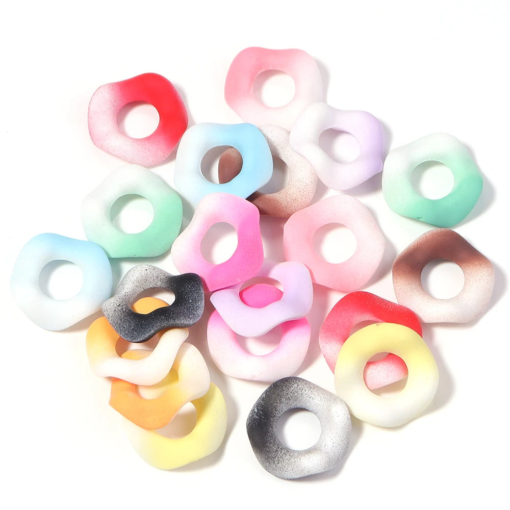 Assortment of colorful acrylic spacer beads in various pastel shades and translucent colors.