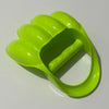 A bright lime green dinosaur claw sand digging toy for kids, shown from above.