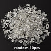 A pile of random silver metal charms and findings for DIY jewelry making