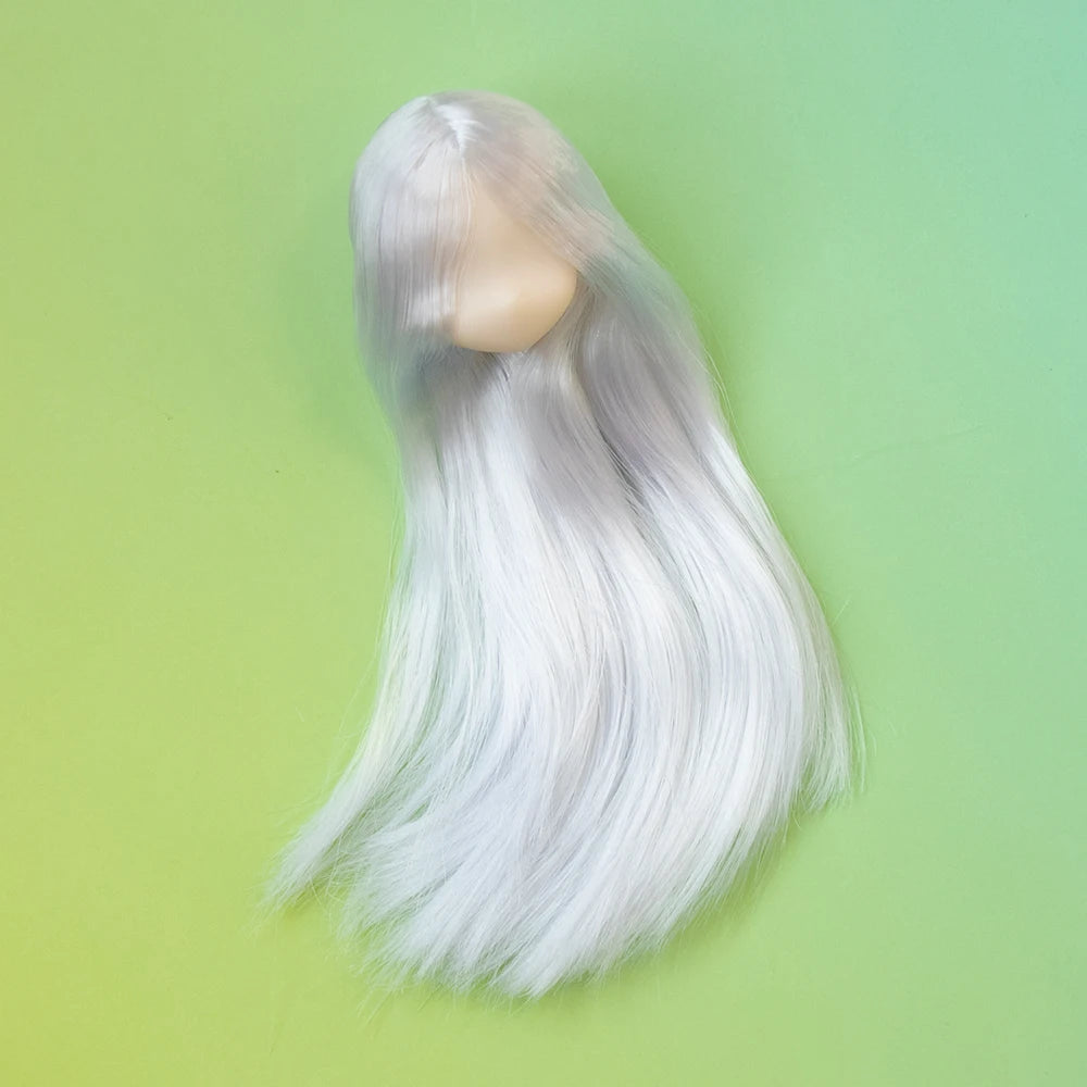 A long, flowing white hair doll with a pale skin tone is displayed against a light green background.