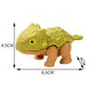 A small, light green finger dinosaur fidget toy with movable joints and a textured skin.