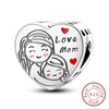 A sterling silver heart charm featuring two women embracing, with the words Love Mom engraved on the surface.
