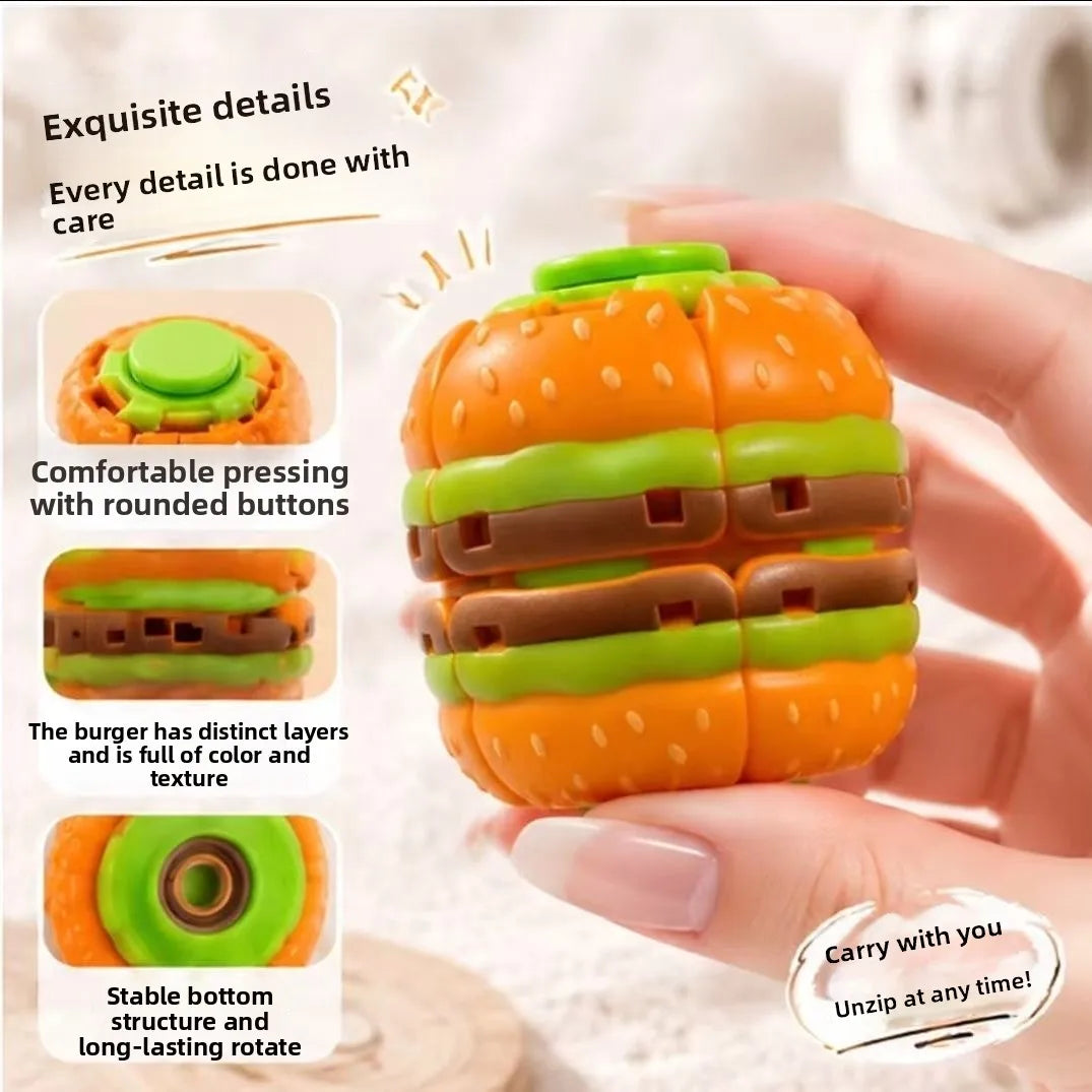 An orange burger-shaped stress relief toy with layered components is held in a hand.