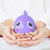 A purple wind-up swimming turtle bath toy is held in cupped hands against a white background.