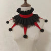 A black and red ruffled clown ruff collar displayed on a white mannequin.