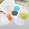 A set of flexible silicone resin molds in various colors and shapes for DIY jewelry making, displayed next to an open book.