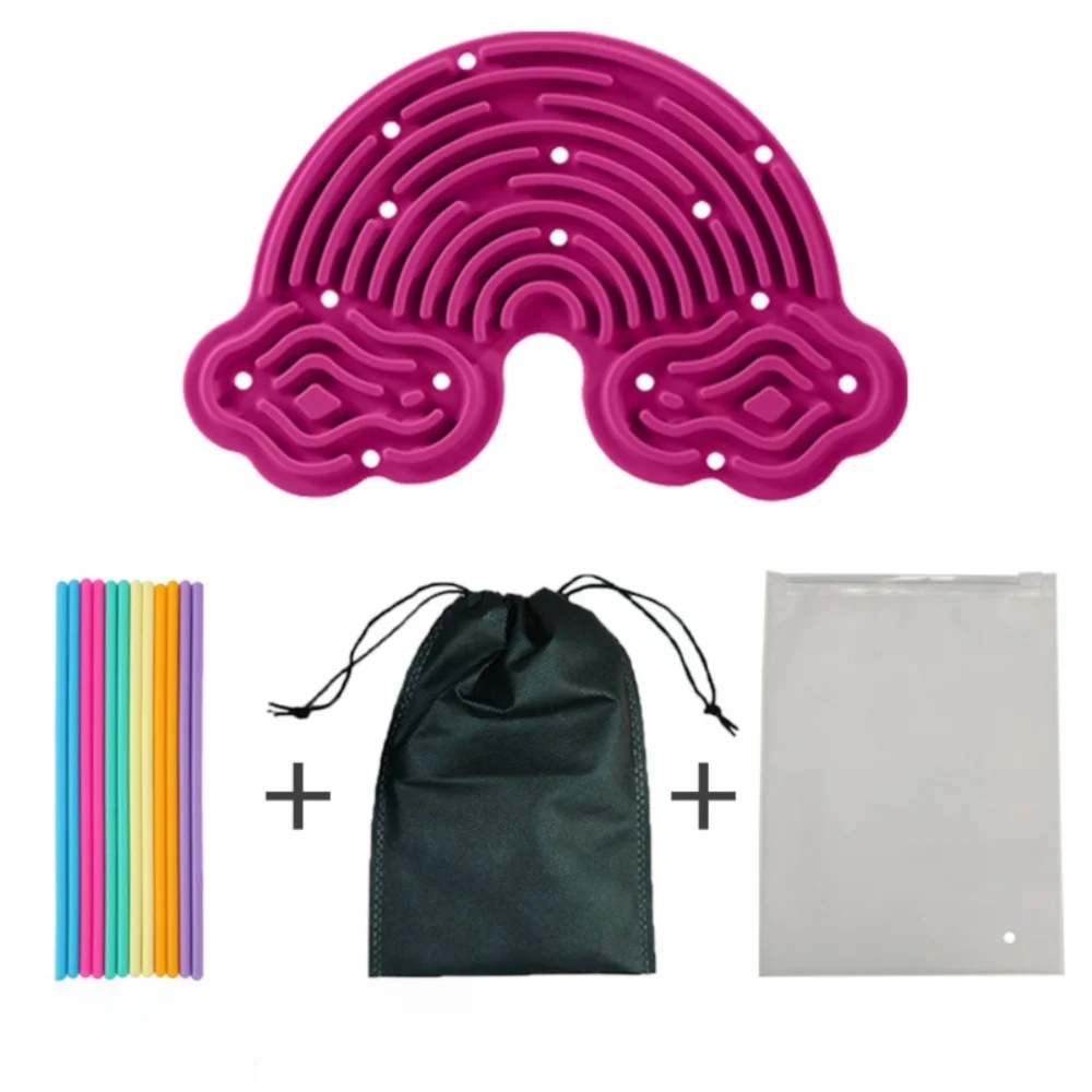 A pink double-sided silicone sensory activity board with 12 strings, a black drawstring bag, and a white plastic bag.