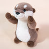A soft brown and white otter plush toy with large eyes and a smiling expression.