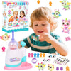 A young child is using a DIY balloon animal craft kit with a pump, stickers, and decorations to make balloons.
