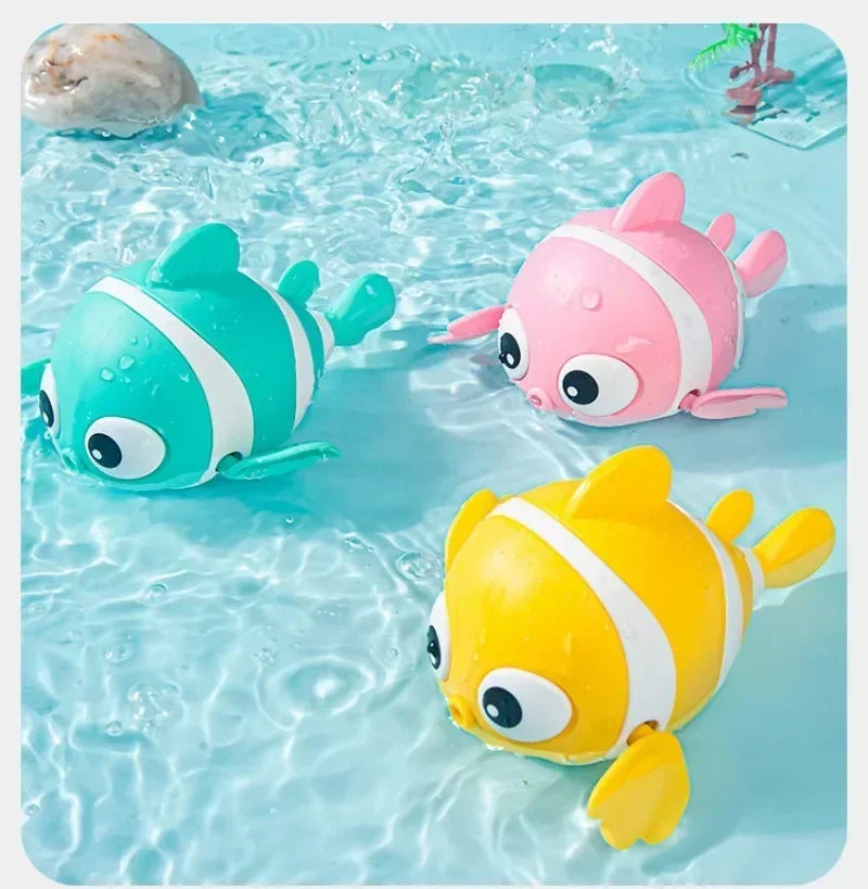 Three colorful wind-up swimming duck bath toys floating in clear water.
