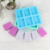 A set of six silicone soap molds with lace patterns in various shades of blue and pink for handmade crafts