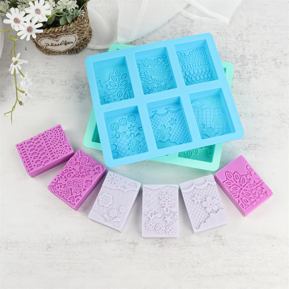 A set of six silicone soap molds with lace patterns in various shades of blue and pink for handmade crafts