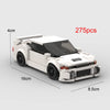 A white classic supercar model built from LEGO-style blocks, shown in a side view.