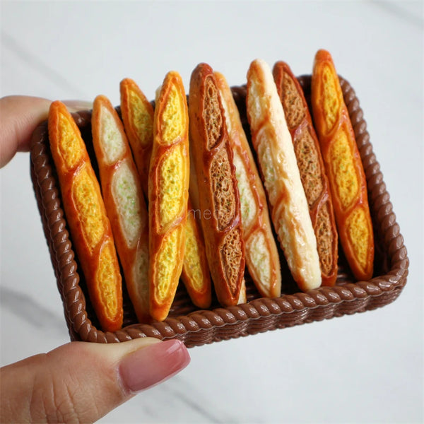 A basket filled with several golden-brown baguette-shaped bread loaves.