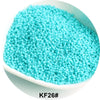 A pile of bright turquoise glass seed beads labeled KF26# in a white dish.