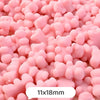 Pink bear-shaped acrylic craft beads with a shimmer finish in a pile