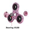 Close-up view of a pink aluminum alloy fidget spinner showing the R188 bearing.