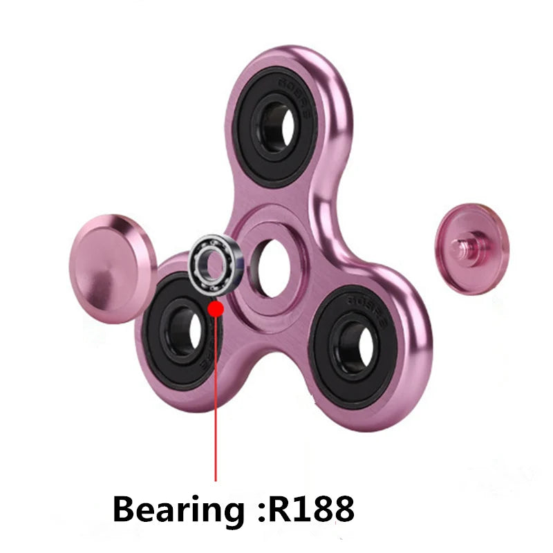 Close-up view of a pink aluminum alloy fidget spinner showing the R188 bearing.