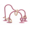 A pink silicone teether ring with a curved handle and a looped end is shown against a white background.