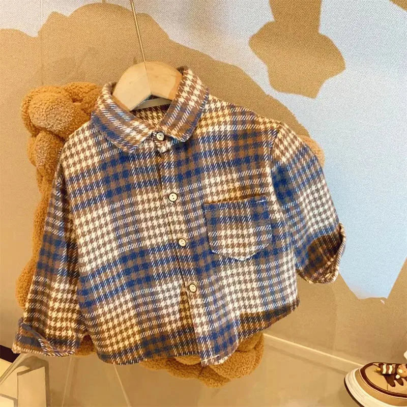 A plaid button-up shirt with brown and blue checks is displayed on a hanger against a light background.