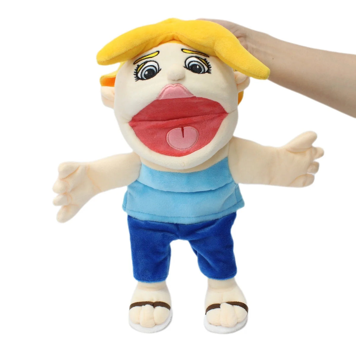 A plush toy of Jeffy featuring yellow hair, a pink mouth, and blue clothing.