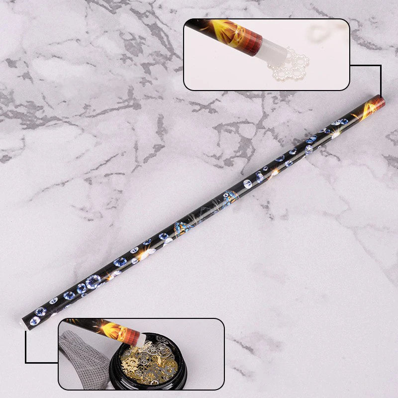 A long, slender pen with a decorative body and a tip showing loose wax nail rhinestones.