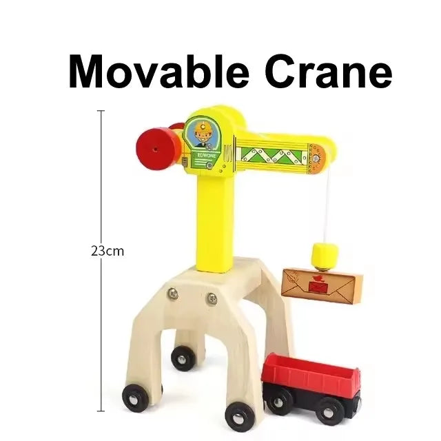 A yellow movable crane toy with a red hook and a wooden train track accessory set.