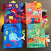 A collection of colorful soft sensory cloth books featuring animals and fun themes for babies.