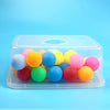 A clear plastic container filled with colorful spherical balls for a party game