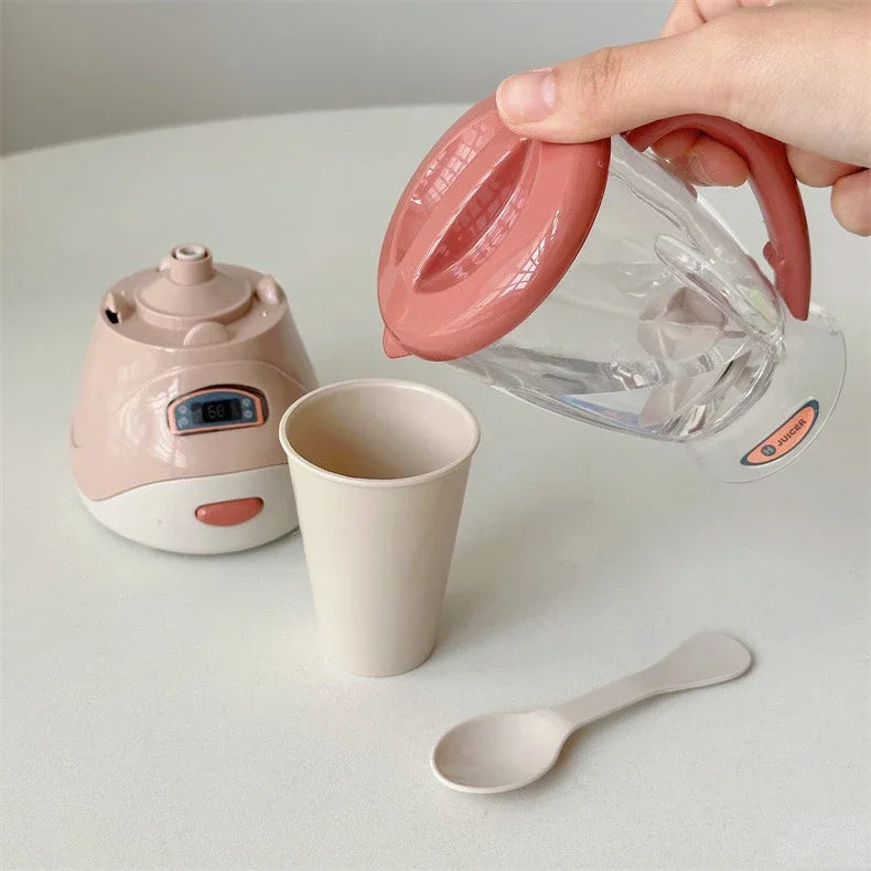 A hand is pouring liquid from a pink plastic dispenser into a clear glass cup, next to a pink kitchen appliance and a small s