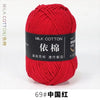 A ball of bright red milk cotton yarn labeled 69# China Red for knitting and crochet.