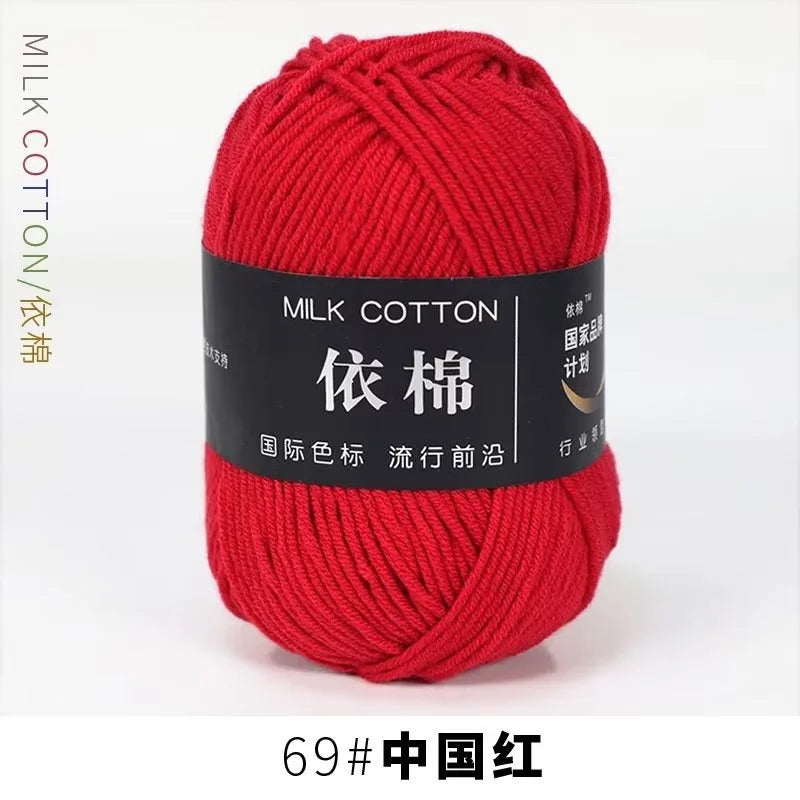 A ball of bright red milk cotton yarn labeled 69# China Red for knitting and crochet.