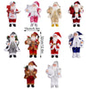 A collection of various Christmas Santa Claus figurines in different outfits and sizes for holiday decor.