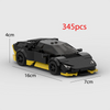 A black and yellow classic supercar building block model with wheels shown from the side.