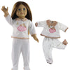 A doll wearing a white casual outfit set with pink accents and a floral collar.