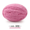 A ball of pink chunky chenille yarn used for hand knitting projects.
