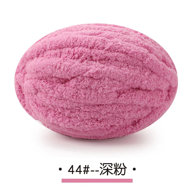 A ball of pink chunky chenille yarn used for hand knitting projects.